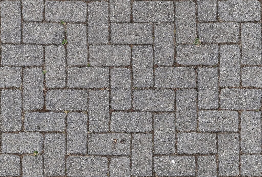 Concrete pavers in a basketweave pattern, a flexible surface that can be lifted and relaid when oak roots push up a River Ridge driveway